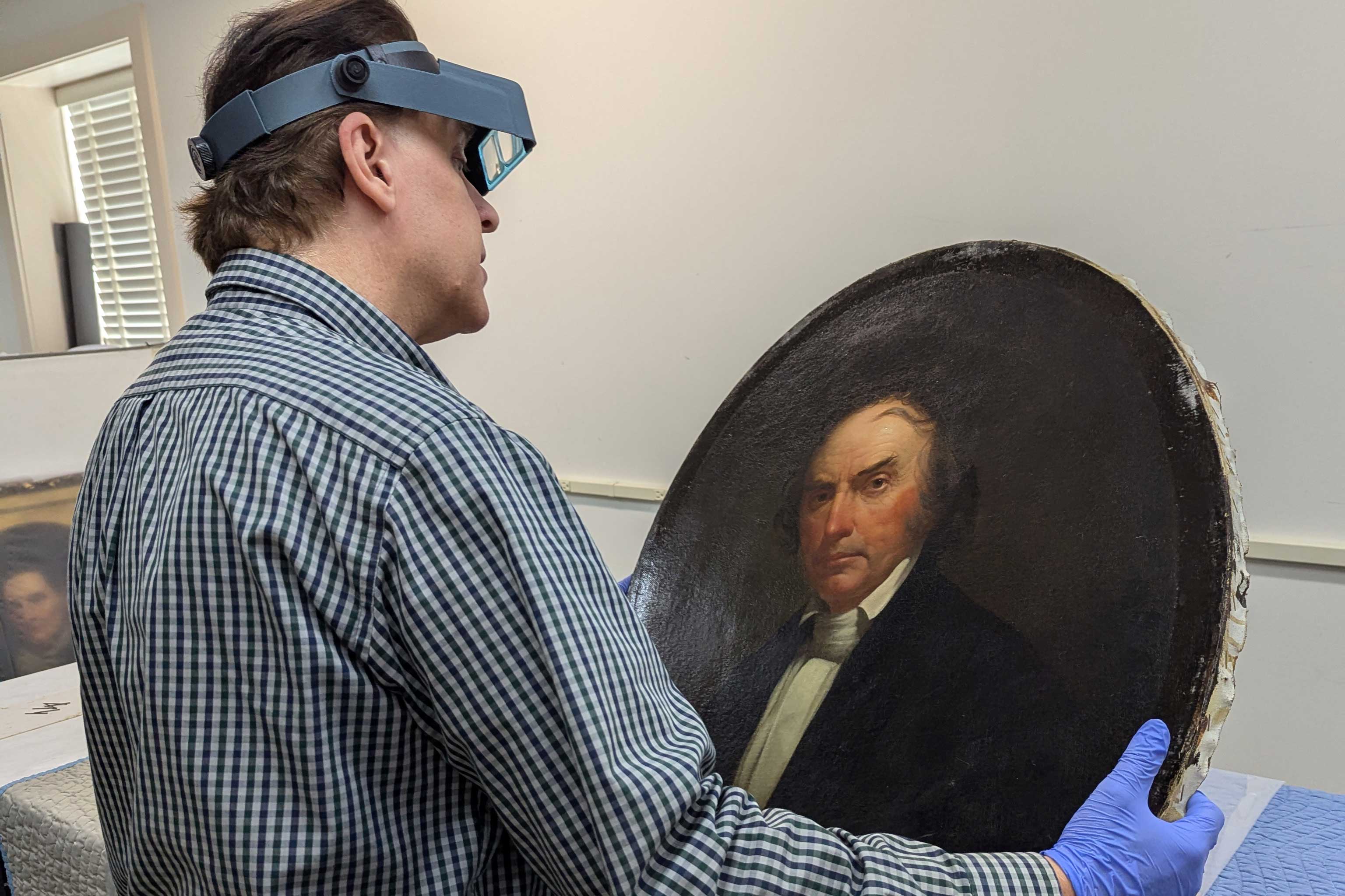 Conservation exam: : Paintings conservator Michael J. Ruzga of Fine Arts  Conservation, Inc., examines the portrait of Nicholas Longworth  out of its frame.  Unknown artist, Nicholas Longworth, about 1857, oil on canvas.  Taft Museum of Art, Gift of Emily Renshaw Pistilli, 2024.001