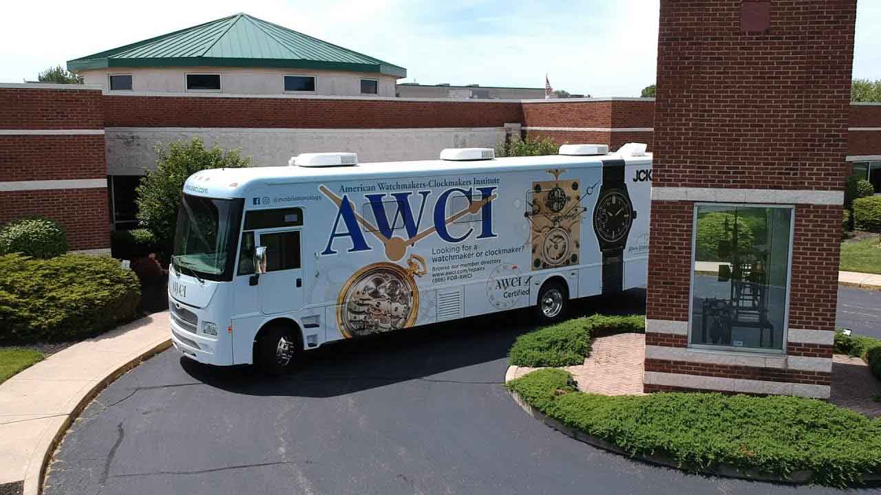 The American Watchmakers and Clockmakers Institute, with the and Archie Perkins Mobile Horology Classroom parked outside